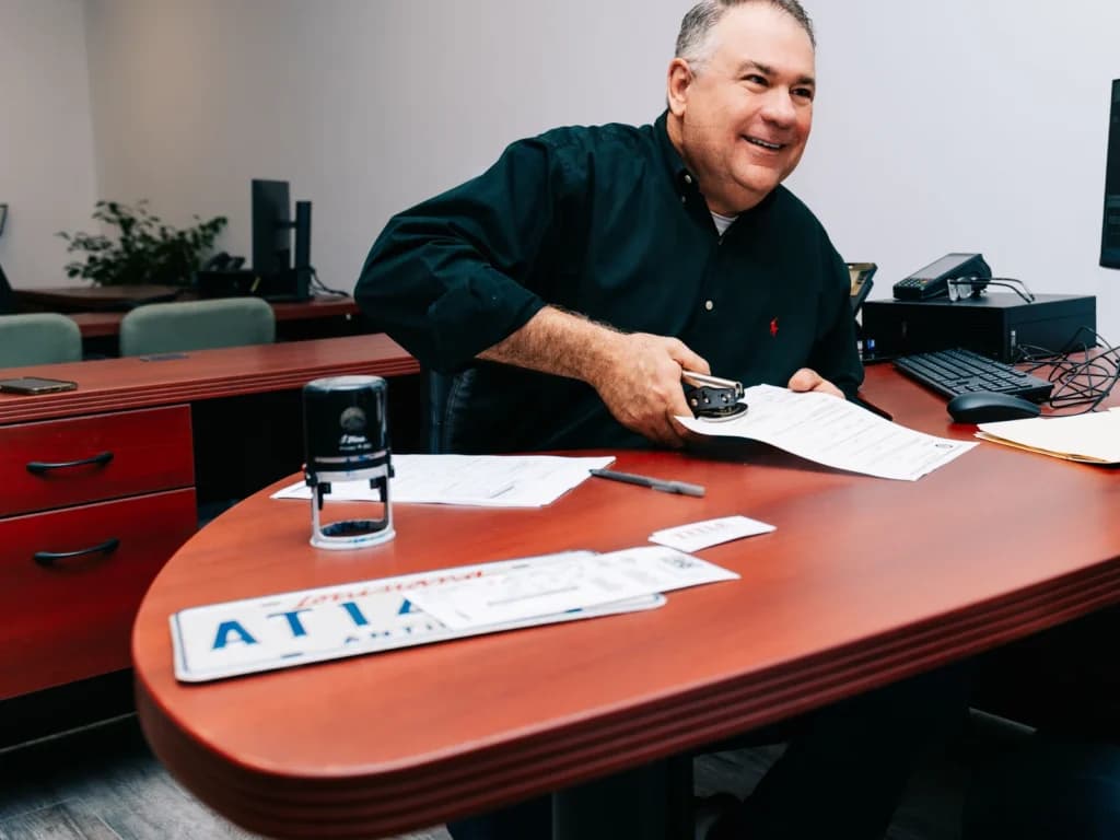 Louis Dutel notarizing documents at the Title Authority office in Covington